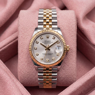 Front view of silver-dial Datejust 31 with diamond-style hour markers, fluted gold-tone bezel and two-tone Jubilee bracelet