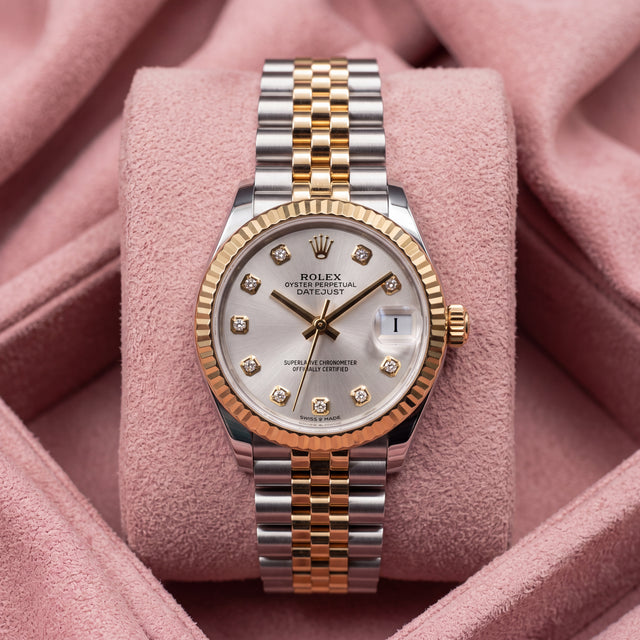 Front view of silver-dial Datejust 31 with diamond-style hour markers, fluted gold-tone bezel and two-tone Jubilee bracelet