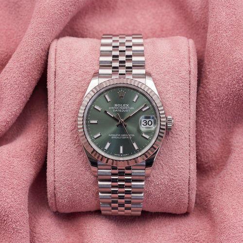 Front view of mint-green dial Rolex Datejust 31 with fluted bezel and Jubilee bracelet on pink cushion