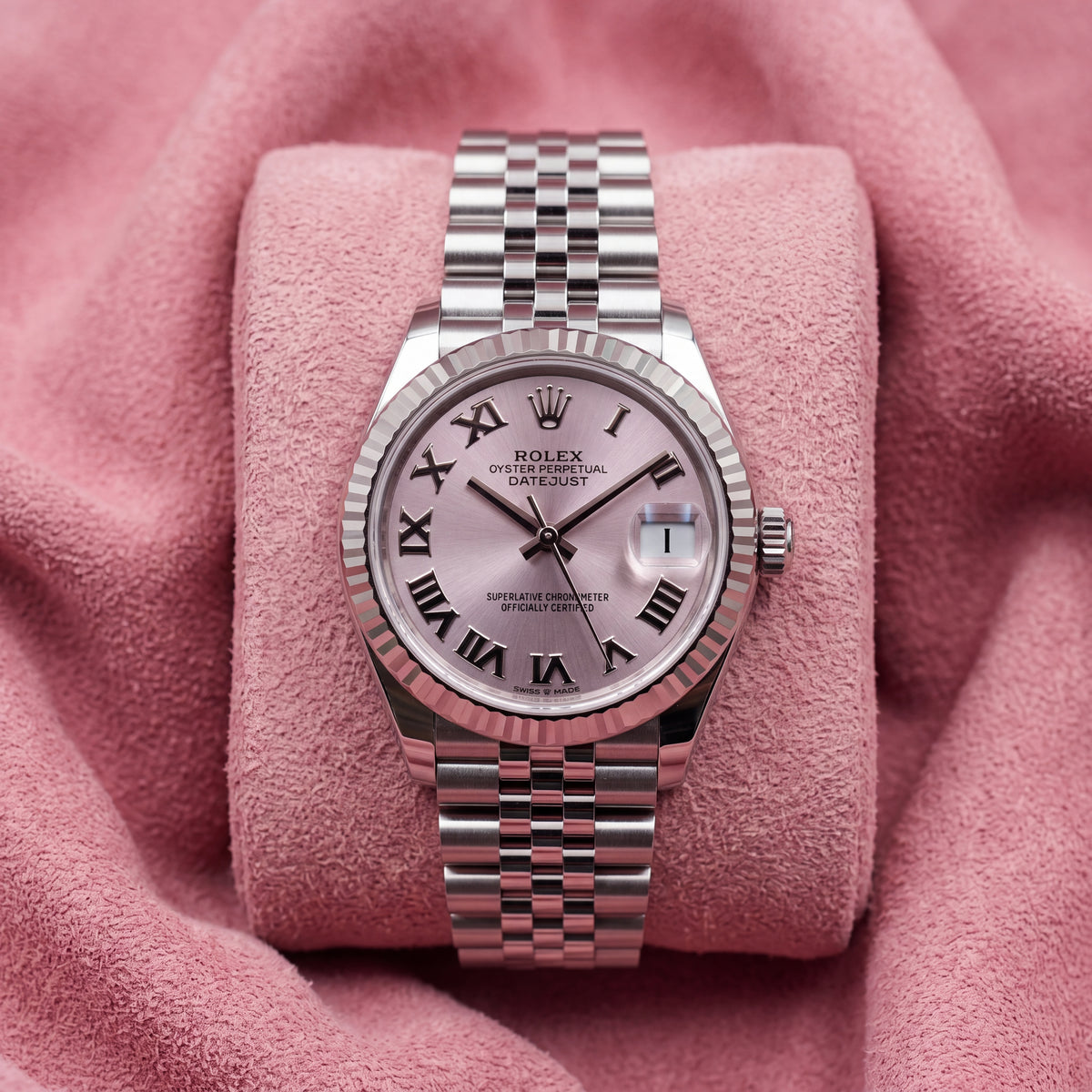 Front view of pink-dial Datejust 31 with Roman-numeral markers, fluted bezel and Jubilee bracelet