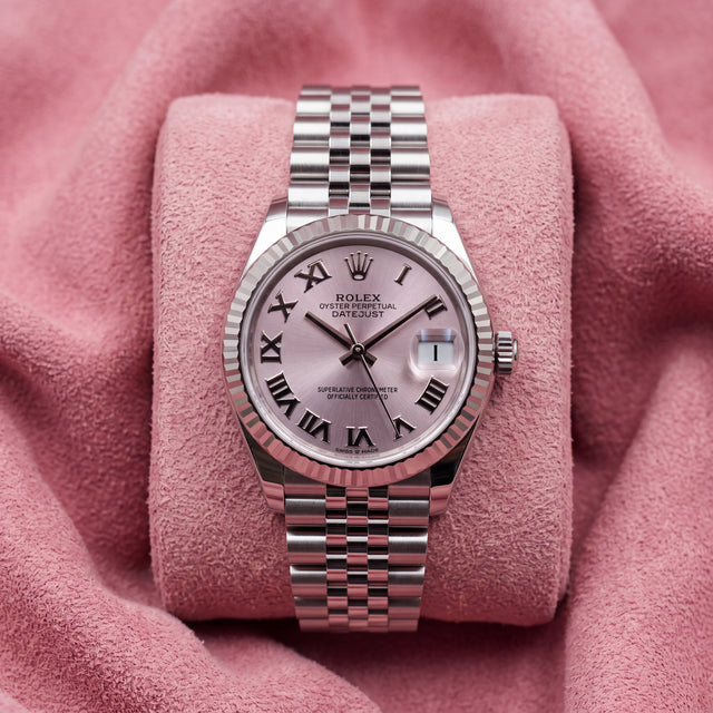 Front view of pink-dial Datejust 31 with Roman-numeral markers, fluted bezel and Jubilee bracelet