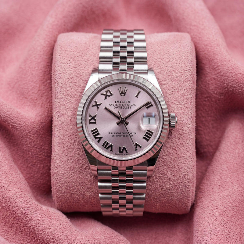 Front view of pink-dial Datejust 31 with Roman-numeral markers, fluted bezel and Jubilee bracelet