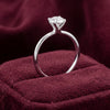 Side view of platinum diamond solitaire engagement ring showing raised four-claw setting