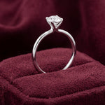 Side view of platinum diamond solitaire engagement ring showing raised four-claw setting