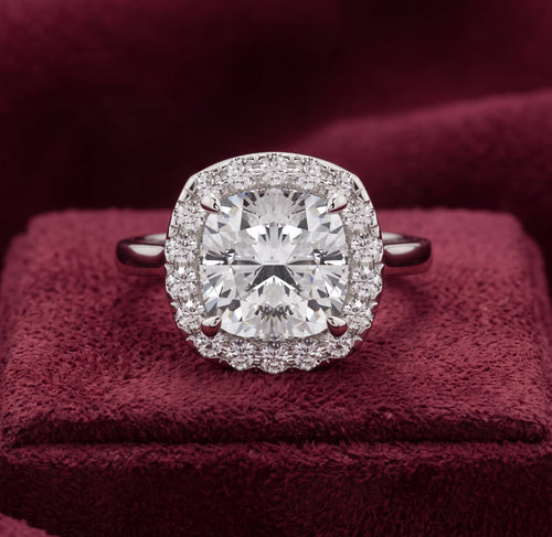 Cushion halo diamond engagement ring with plain shoulders, front view