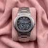 Patek Philippe Nautilus 5712/1A-001 with blue-grey striped moon-phase dial and integrated silver-toned bracelet on a pink cushion
