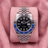 Front view of black-dial GMT-Master II with blue-and-black bezel and Jubilee bracelet on pink cushion