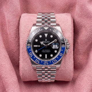 Front view of black-dial GMT-Master II with blue-and-black bezel and Jubilee bracelet on pink cushion