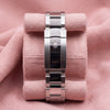Rolex Oyster bracelet with polished centre links and crown-embossed clasp on a pink cushion