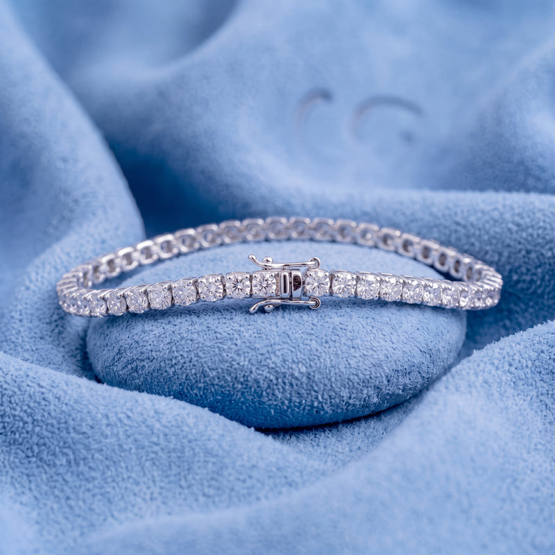 Platinum round brilliant-cut diamond tennis bracelet on a soft blue background