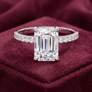 Platinum emerald-cut diamond engagement ring with diamond shoulders, front view