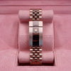 Rear view of rose-tone Jubilee bracelet and crown-emblem clasp on pink cushion