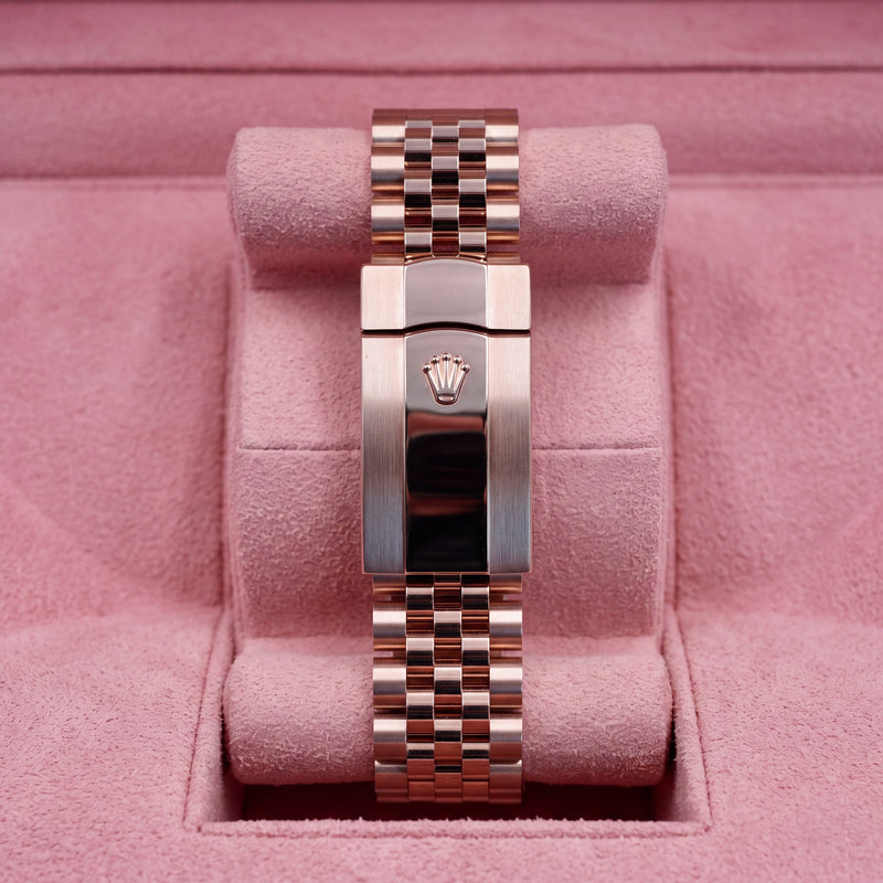 Rear view of rose-tone Jubilee bracelet and crown-emblem clasp on pink cushion