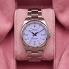 Front view of lavender-dial Oyster Perpetual watch with smooth steel bezel and Oyster bracelet on pink cushion