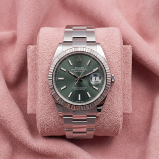 Rolex Datejust 41 with mint green dial, fluted bezel and Oyster bracelet on a pink cushion