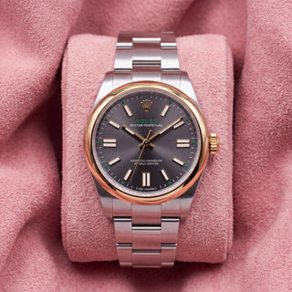 Rolex Oyster Perpetual 41 134303 with grey dial, green accents, 100 YEARS inscription and smooth gold-tone bezel