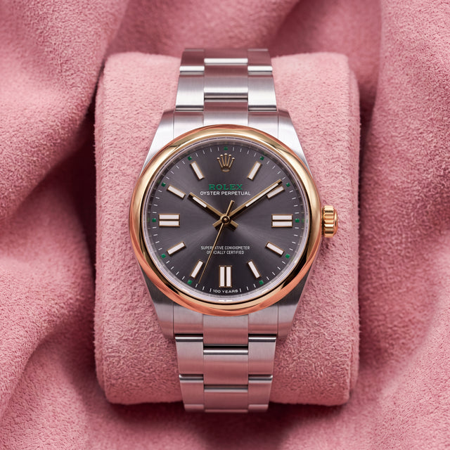 Rolex Oyster Perpetual 41 134303 with grey dial, green accents, 100 YEARS inscription and smooth gold-tone bezel