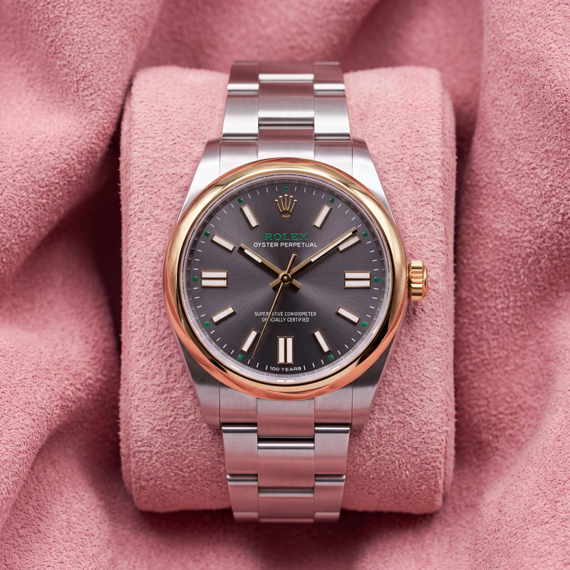 Rolex Oyster Perpetual 41 134303 with grey dial, green accents, 100 YEARS inscription and smooth gold-tone bezel