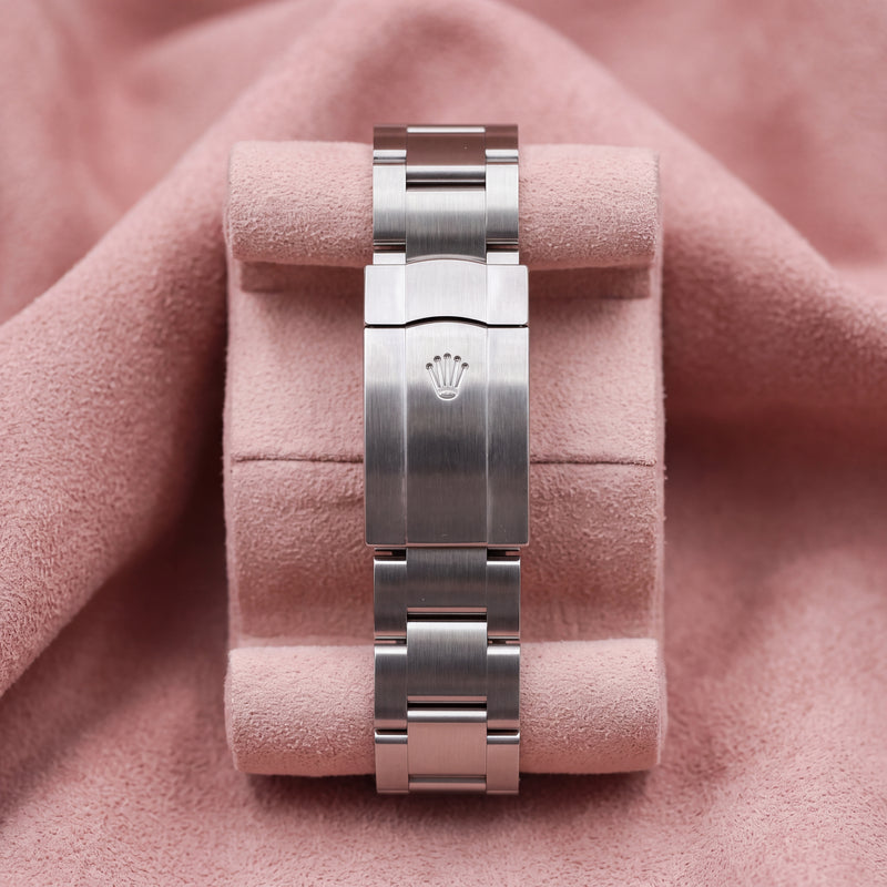 Rolex Oyster bracelet with crown-embossed clasp on a pink cushion