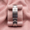 Rear view of stainless-steel Oyster bracelet and crown-emblem clasp on pink cushion