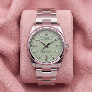 Rolex Oyster Perpetual 41 with pistachio dial and Oyster bracelet on a pink cushion