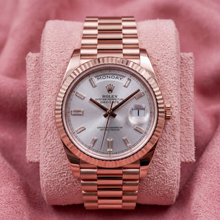 Rolex Day-Date 40 228235 with Sundust baguette dial and rose gold fluted bezel