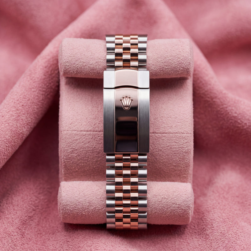 Steel and rose-gold Rolex Datejust Jubilee bracelet with crown-emblem clasp on a pink cushion