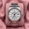 Rolex Sky-Dweller with white dial, fluted bezel and Oyster bracelet on a pink cushion